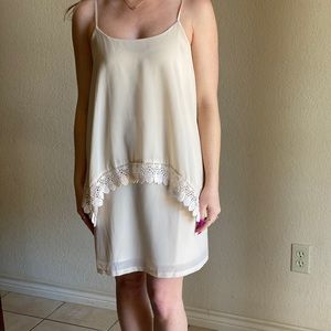 Cream color dress, with lace embroidery.